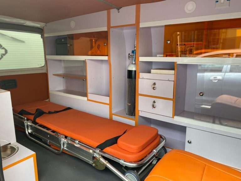 Inside an ambulance: a stretcher, an oxygen cylinder and equipment cabinets