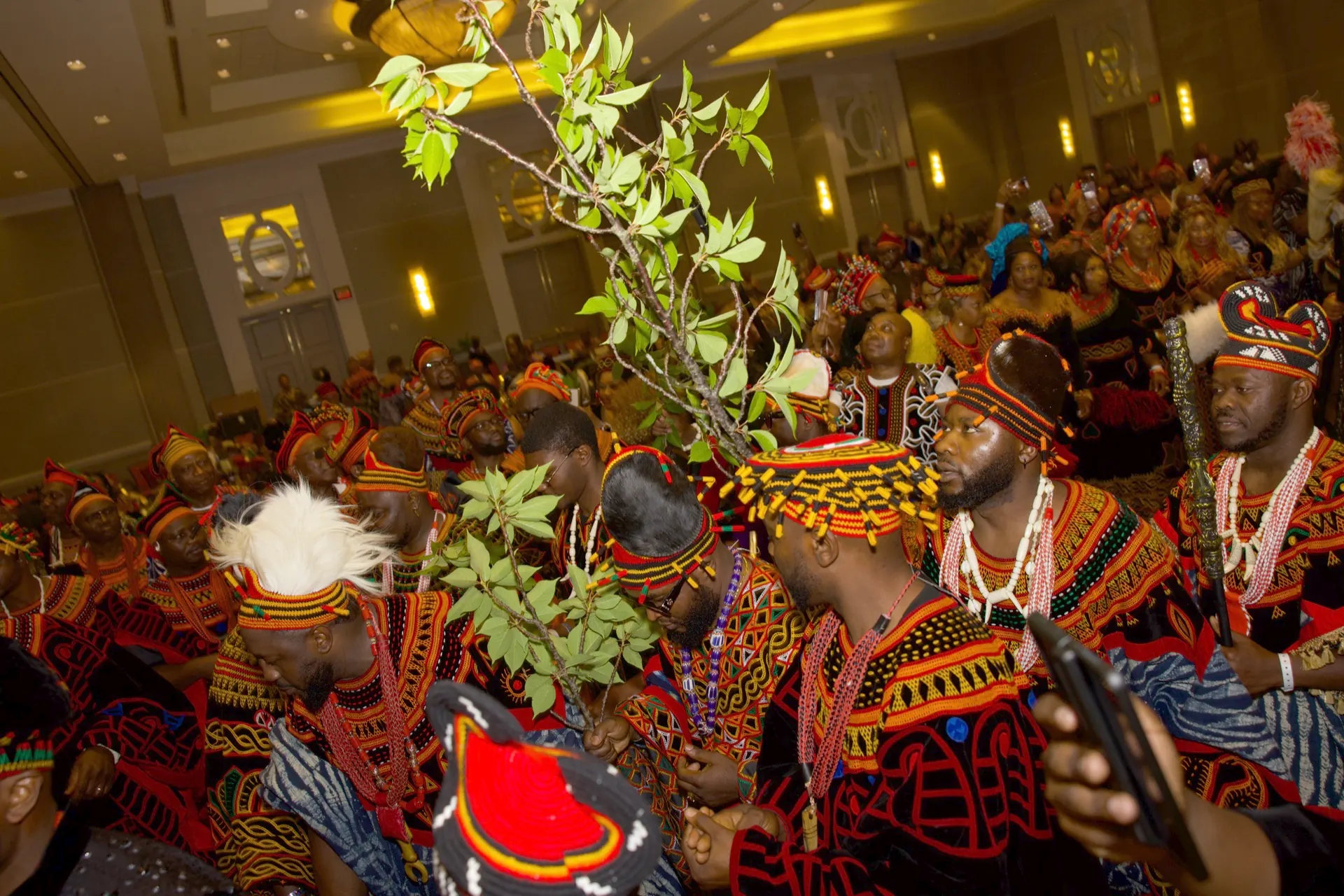 BCA-USA members in traditional regalia carrying peace plants in a procession