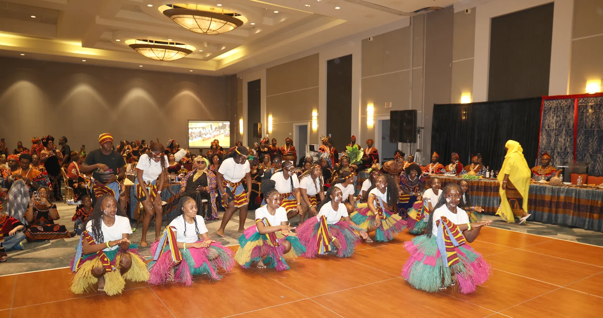 Young dancers performing before a full convention hall